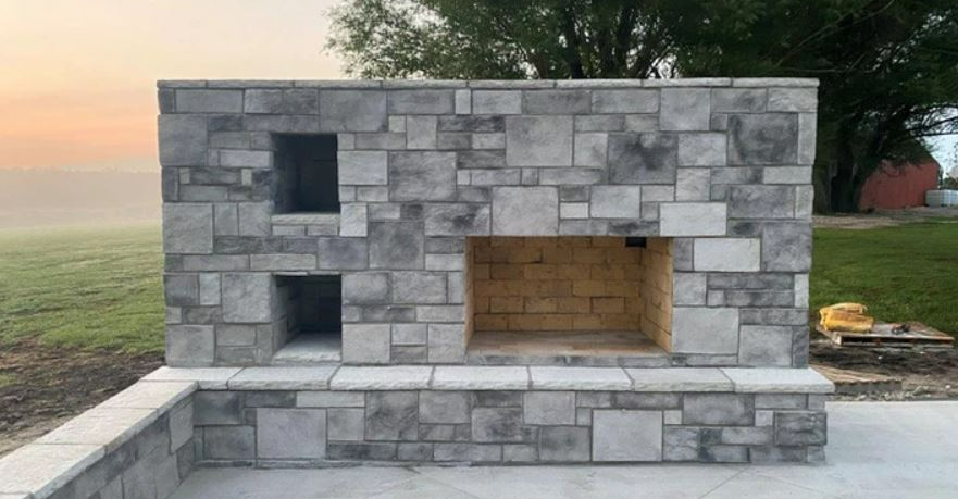Outdoor stone fireplace at dusk